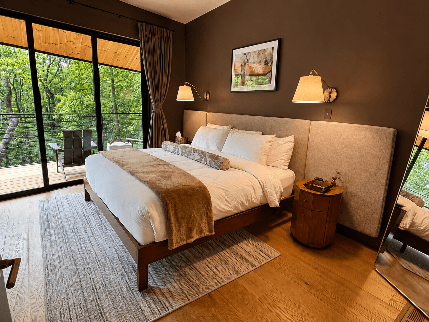 Villa master bedroom with floor-to-ceiling forest canopy views at Cypress Resort